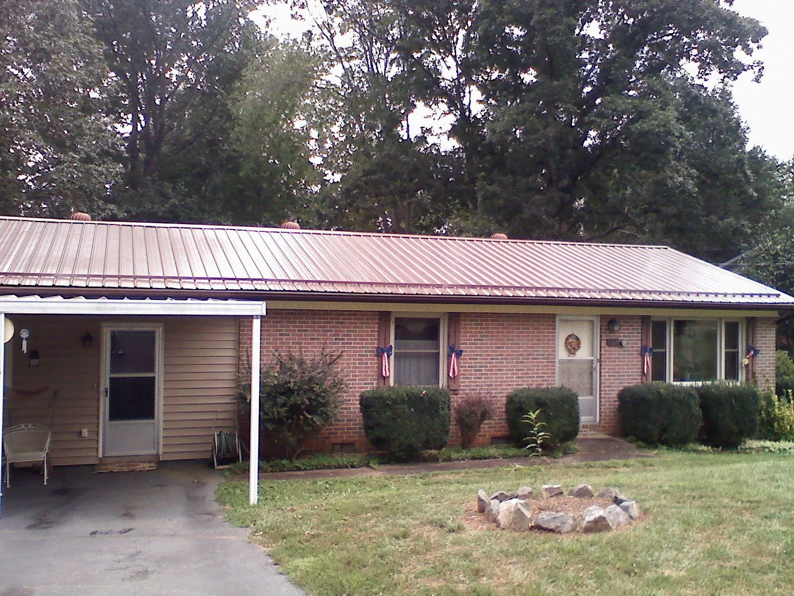 Bronze metal roof and carport on a brick ranch home — Roof Repair work by our crew in North Reading